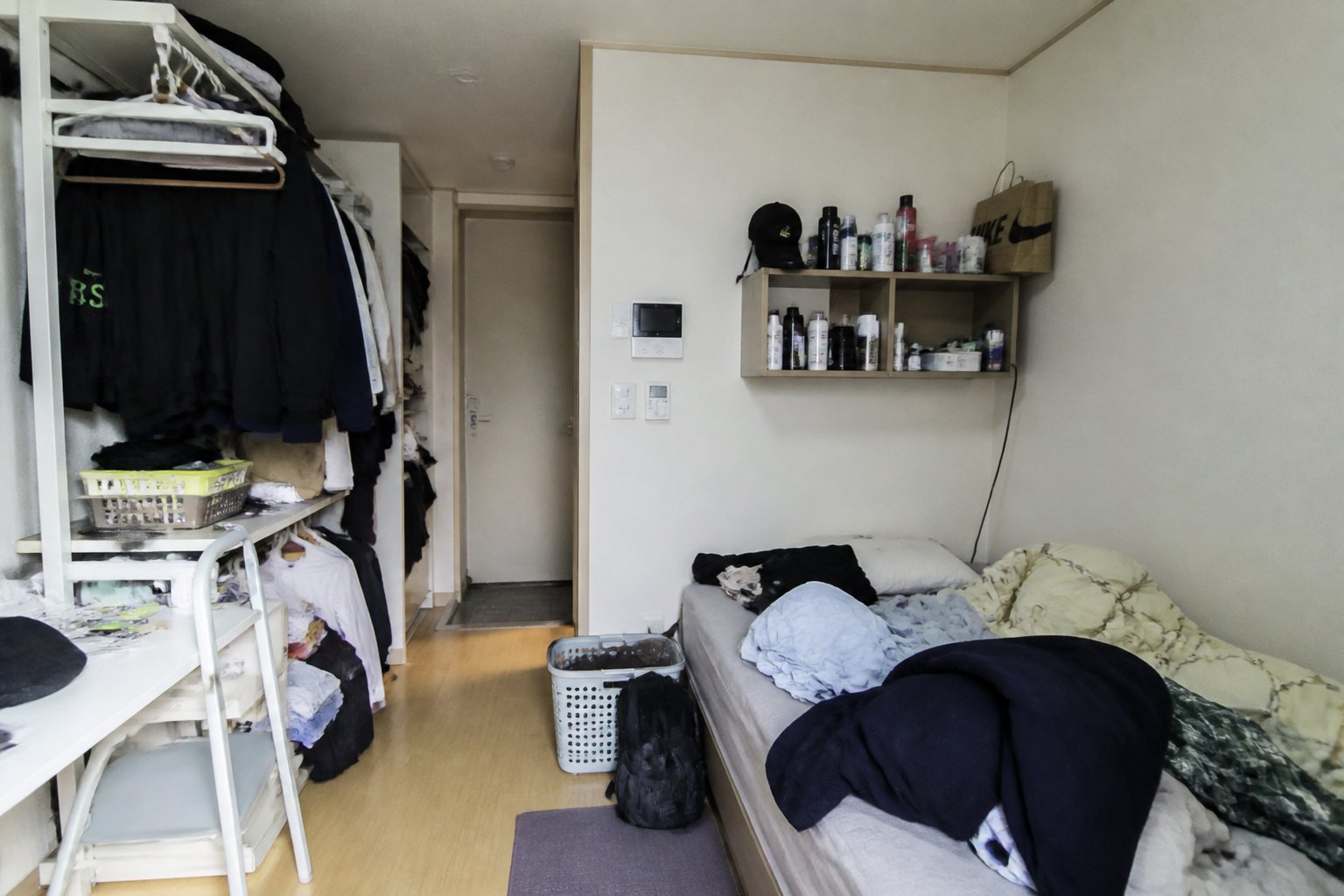 원룸의 좁은 공간에 물건이 어지러이 쌓여 있는 모습